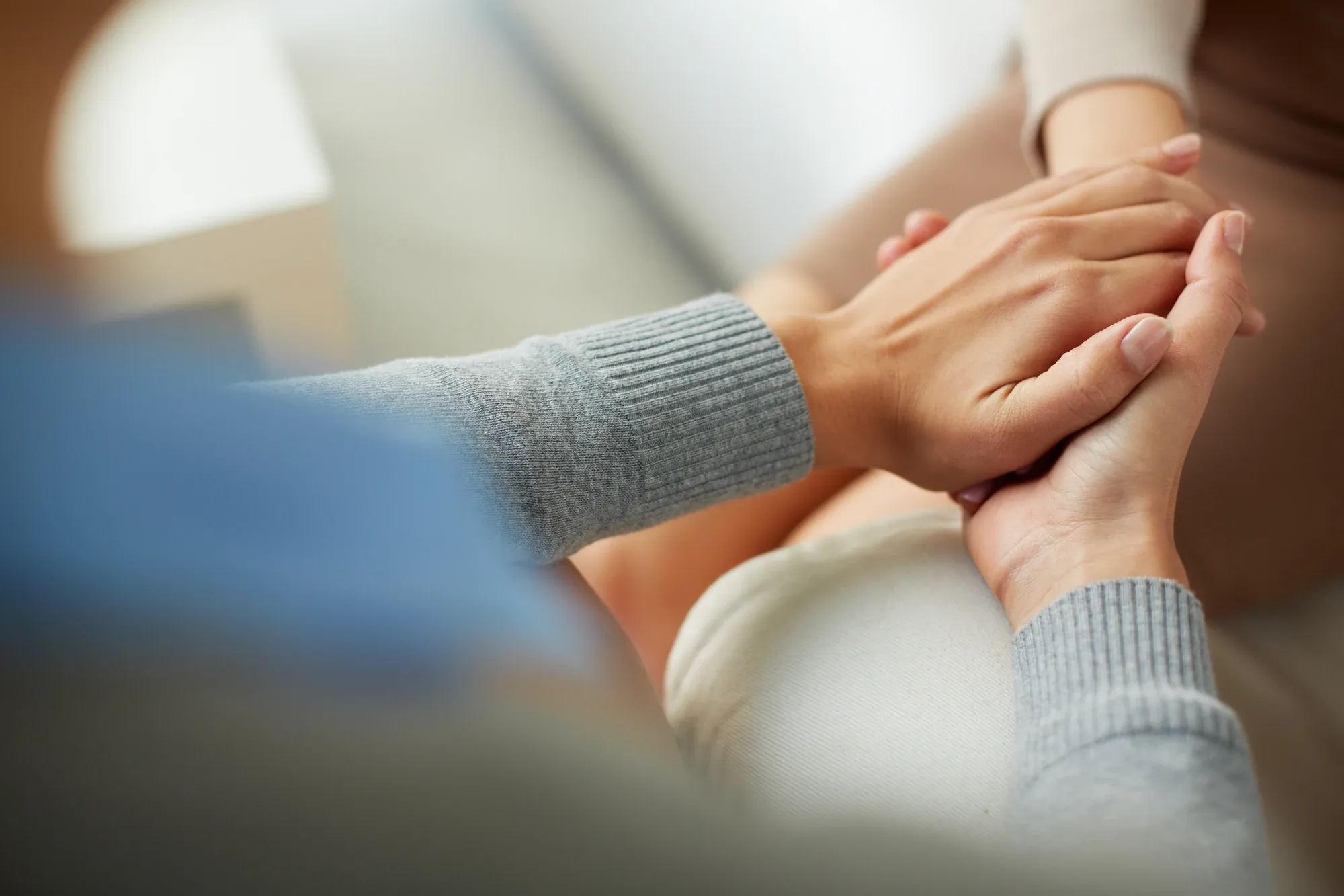 Therapist holding a client's hand