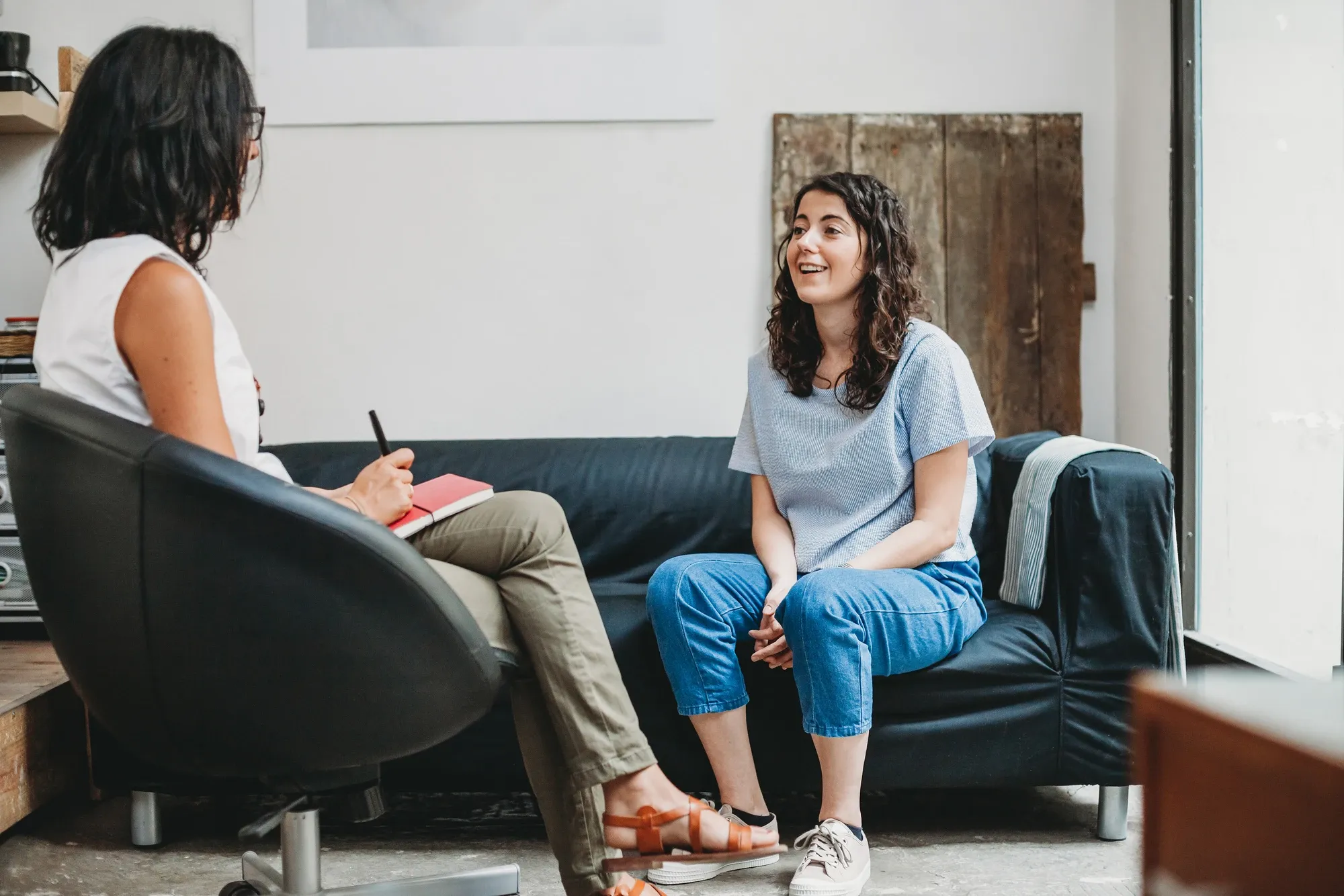 therapist and client sitting on a couch