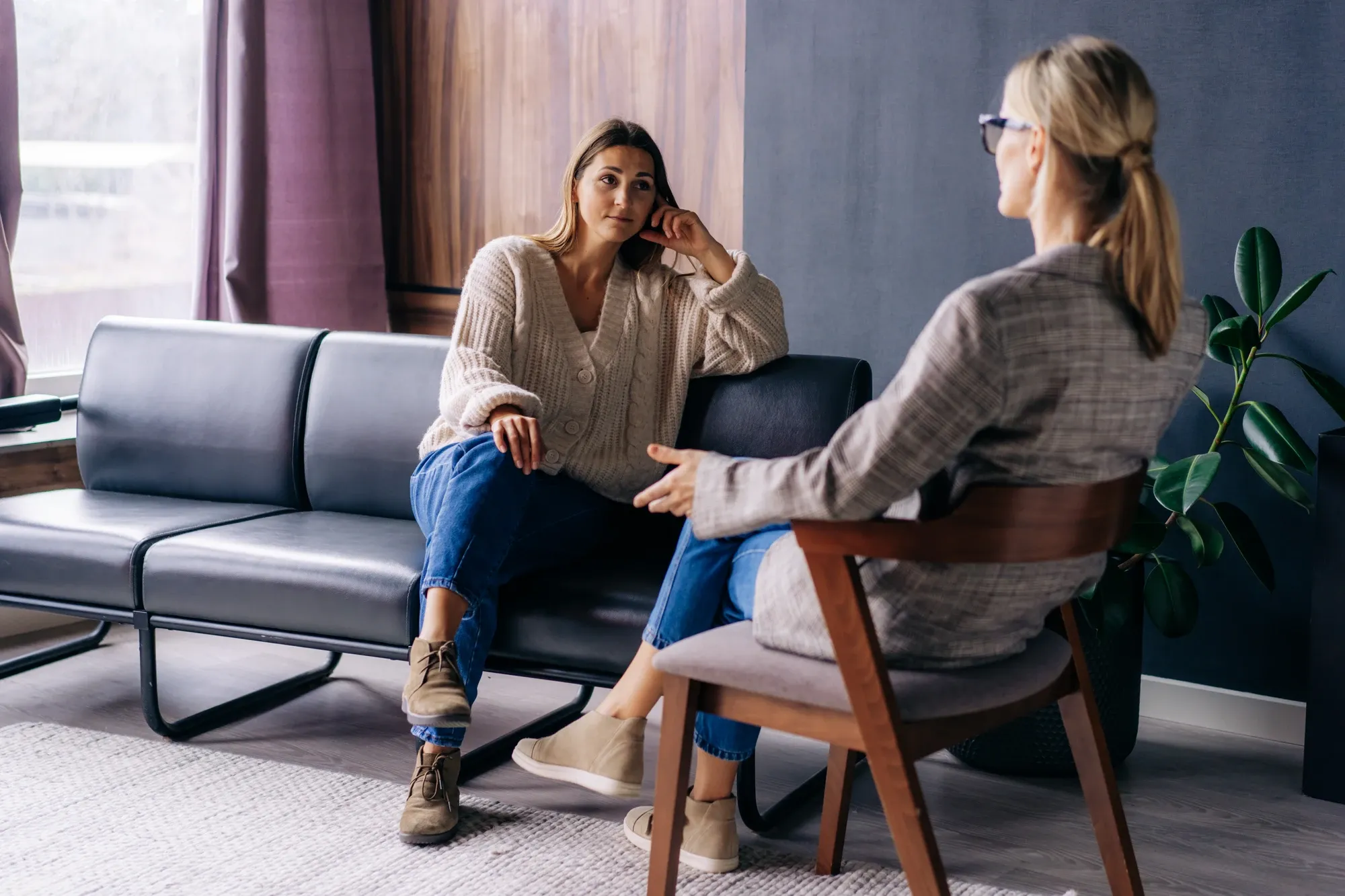 therapist and client sitting on a couch