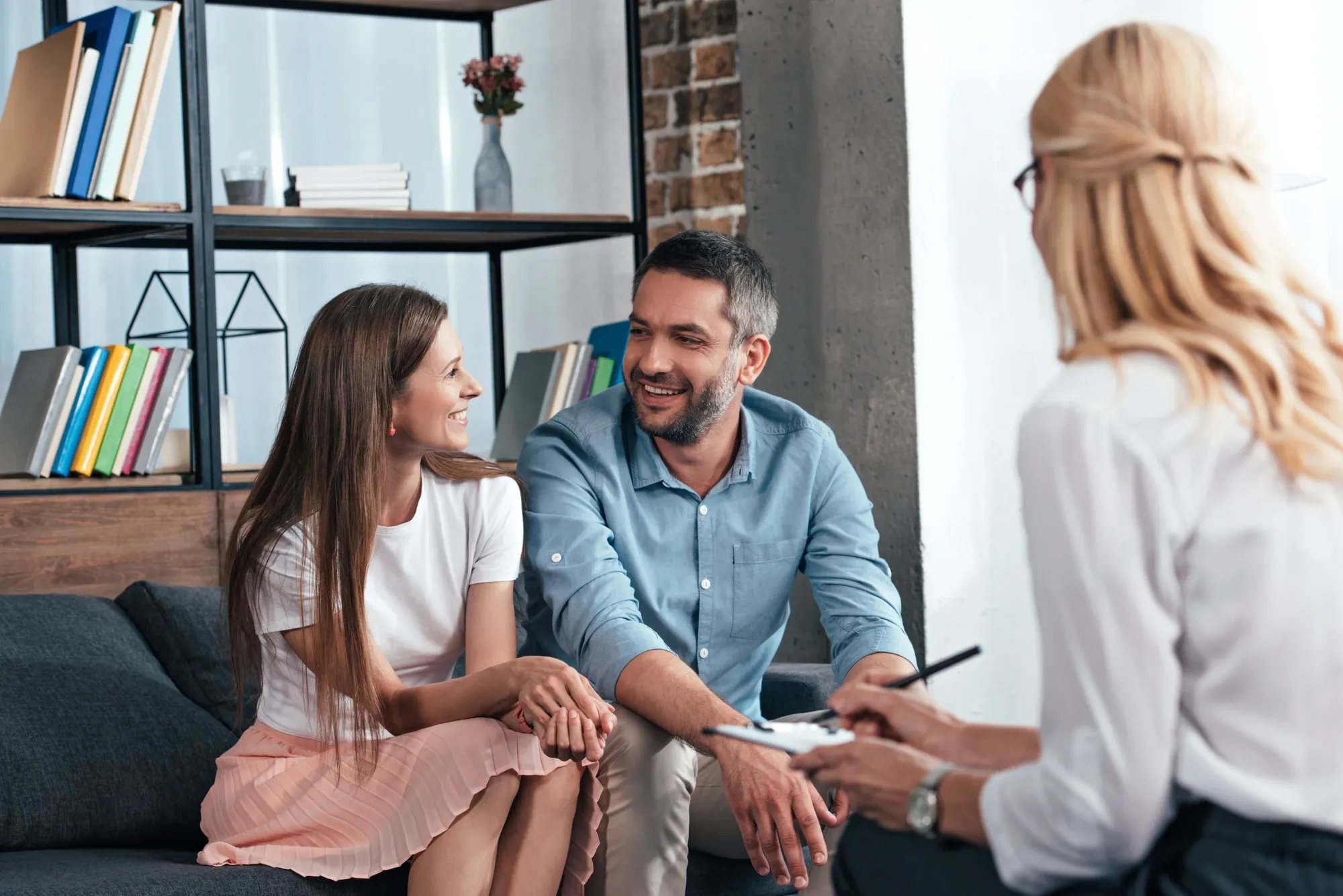 therapist and couple sitting on a couch